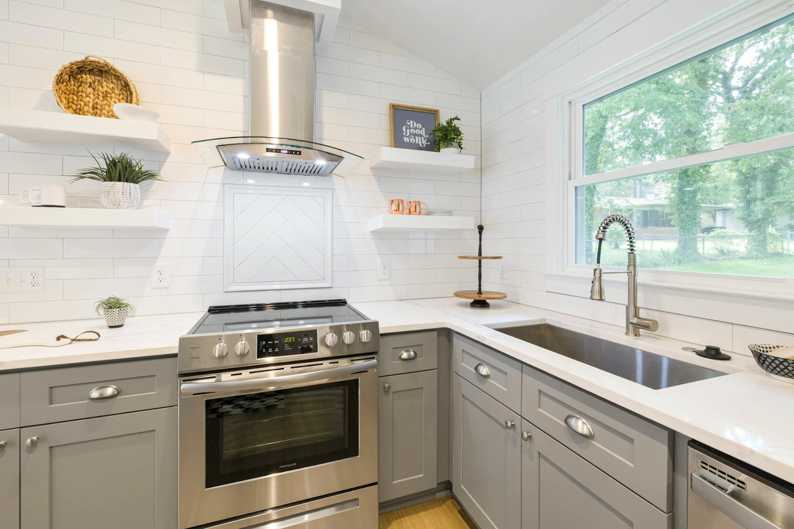 A kitchen uses open shelves for decor items, and lower closed cabinets are utilized for hidden storage.