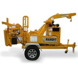 Yellow wood chipper machine on wheels, side view.