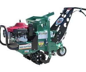 Green and black compact trencher machine with a red engine, designed for efficient digging and trenching tasks.