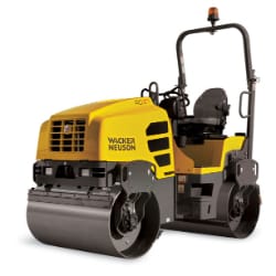 Yellow road roller with a black seat and steering wheel, used for compacting asphalt in construction and roadworks.