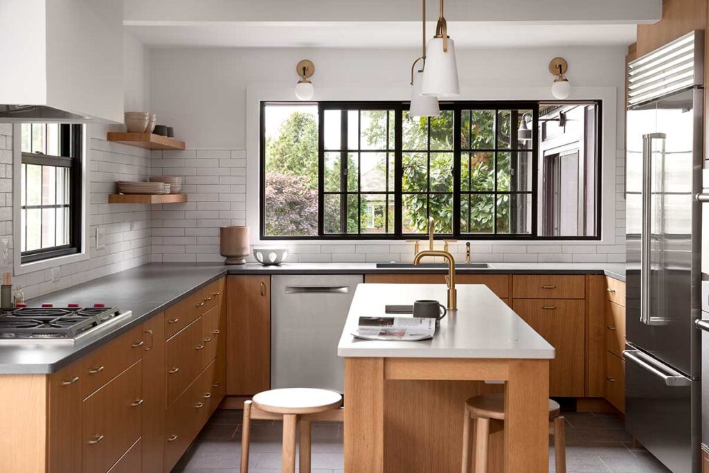 This image depicts a bright, modern kitchen with black-trimmed sliding windows for functionality and aesthetic appeal.