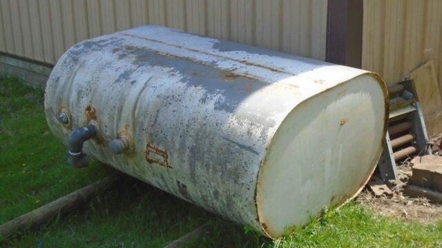 A large propane tank installed at a residence is positioned outside for fuel storage and heating needs.