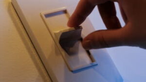 woman's hand on dimmer switch
